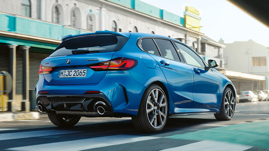 BMW 1 серії F40 у кольорі Misano Blue metallic, вид ззаду на три чверті BMW 1 серії F40 у кольорі Misano Blue metallic, вид ззаду на три чверті під час руху