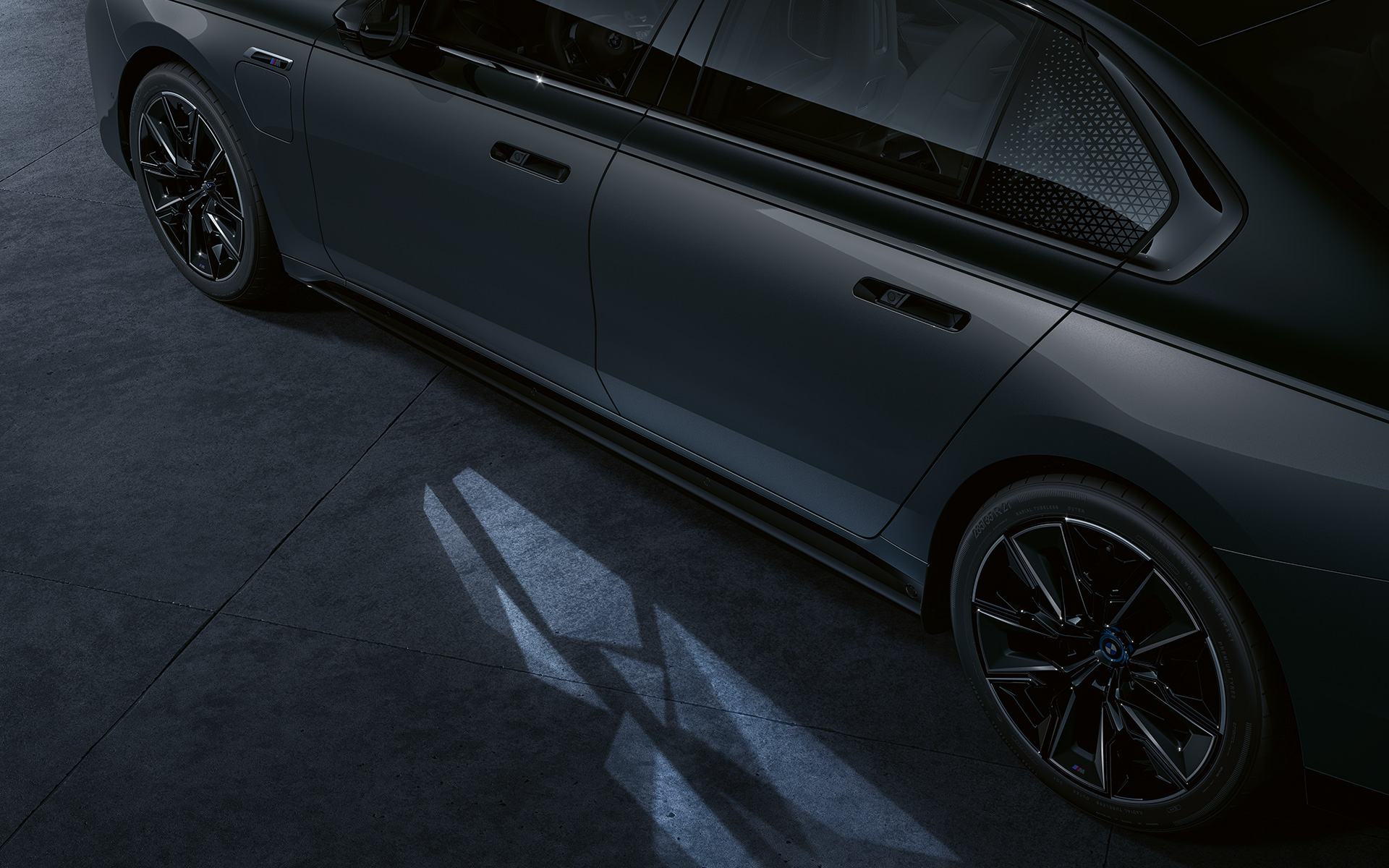 Концепт Lightning BMW M760e xDrive Седан G70 Двоколірне забарвлення BMW Individual Dravite Grey metallic вид збоку великим планом з Welcome Light Carpet