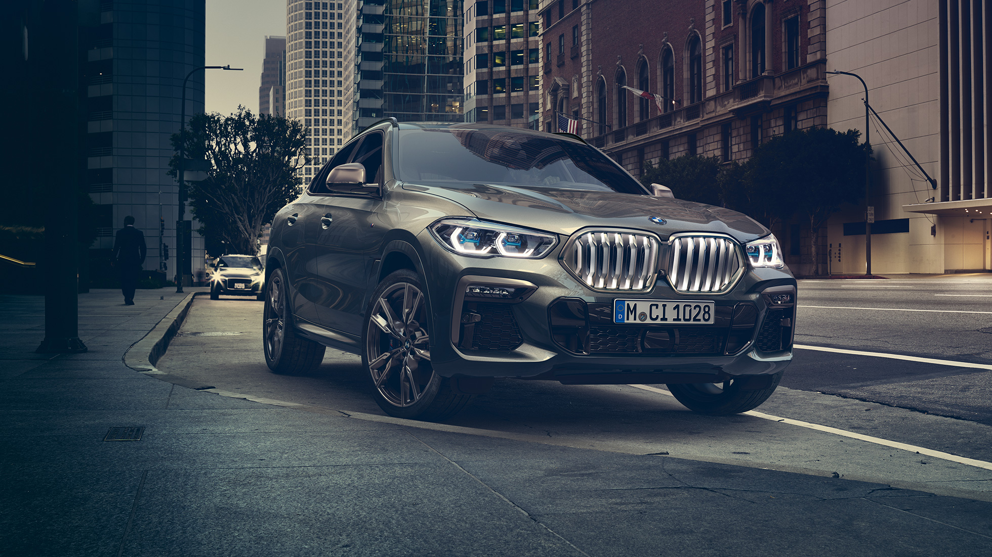 Адаптивна підвіска BMW X6 M Professional. BMW X6, передня частина з поворотом в три чверті перед міською обстановкою.